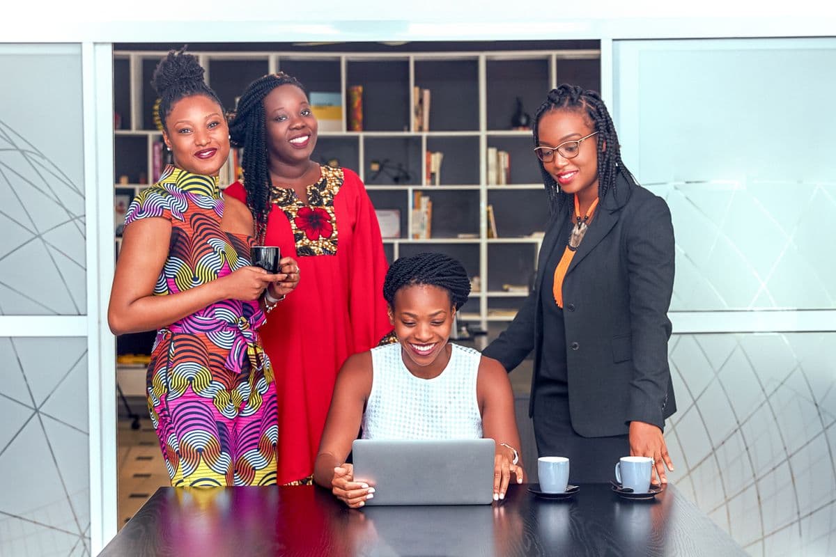 African women collaborating in a savings group meeting
